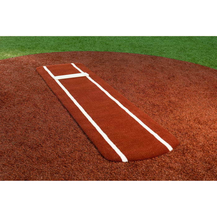 Portolite Ultimate Spiked Practice Mat in red clay on a softball pitching mound